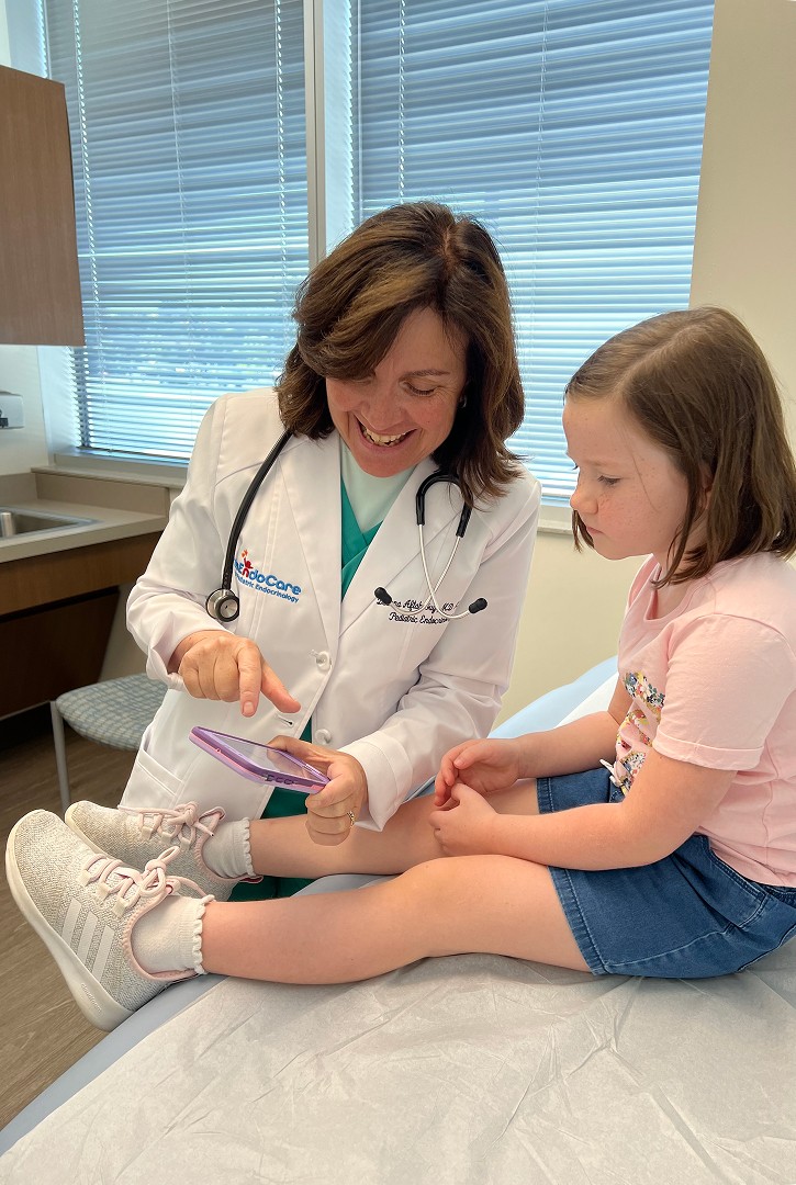 Dr. Deanna Aftab Guy with a young patient