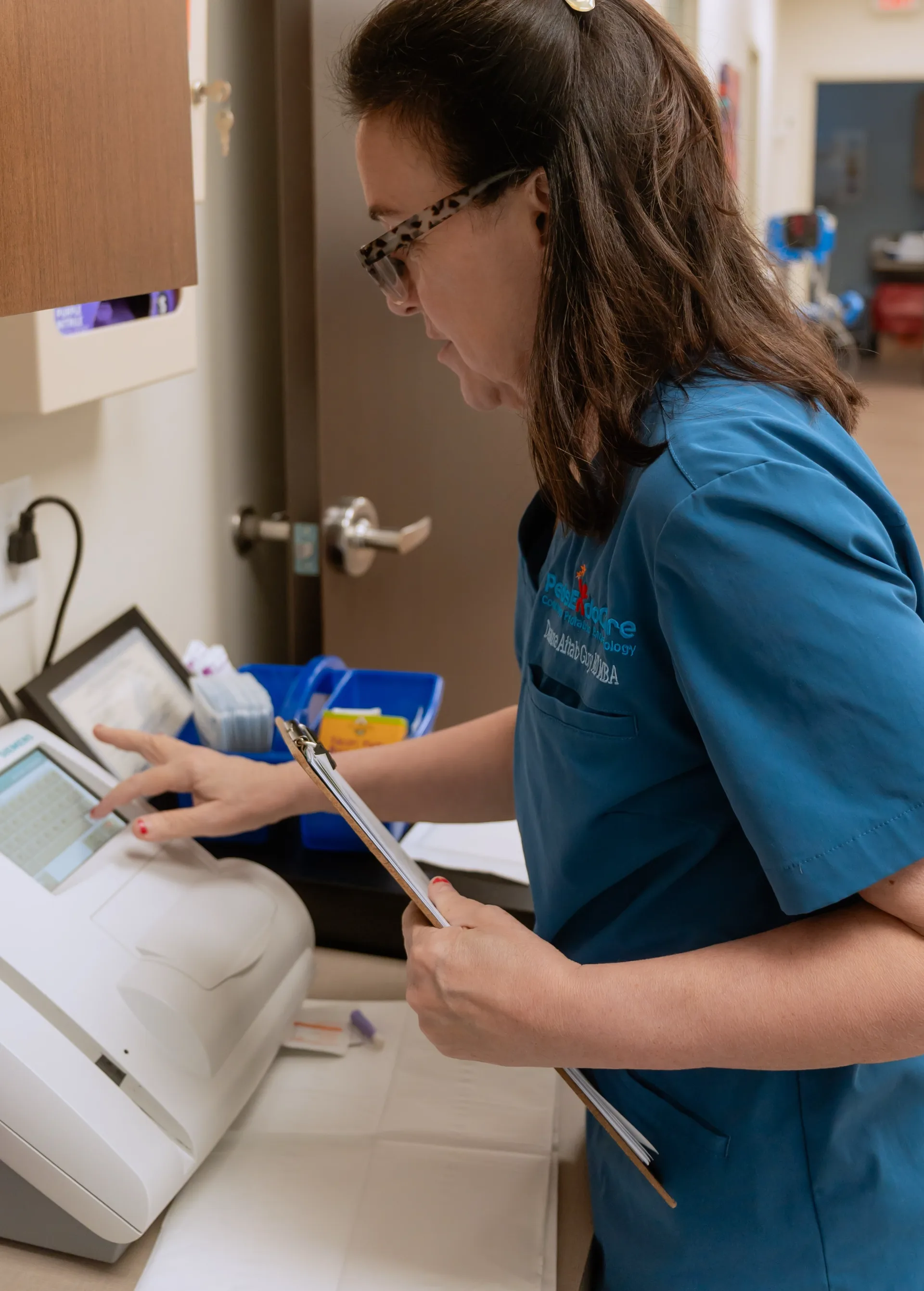 Dr. Aftab Guy reviewing notes beside the practice testing equipment