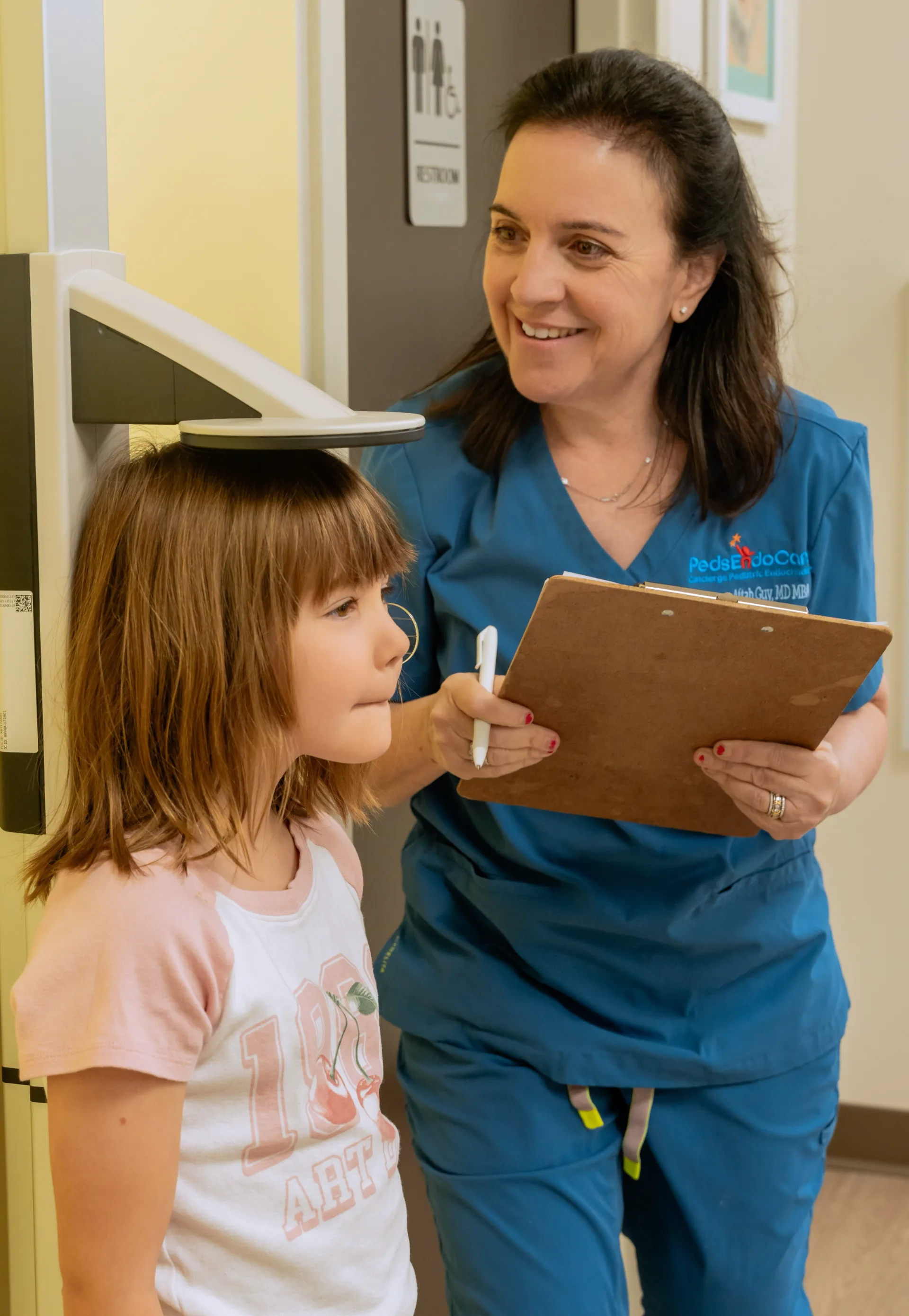 Dr. Aftab Guy reviewing a young patient's chart together with her during an unhurried visit