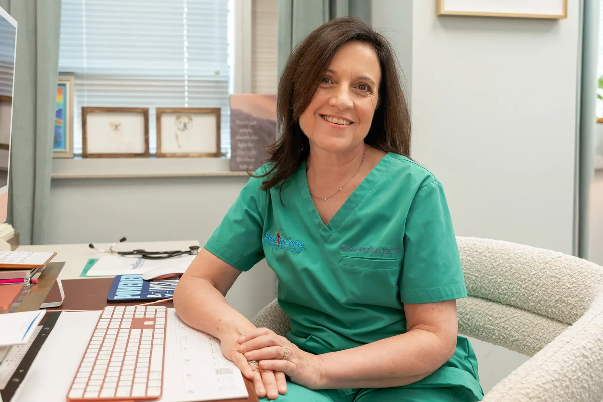 Dr. Deanna Aftab Guy at her desk in the practice office